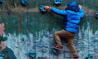 Photo of Boy Wall Climbing